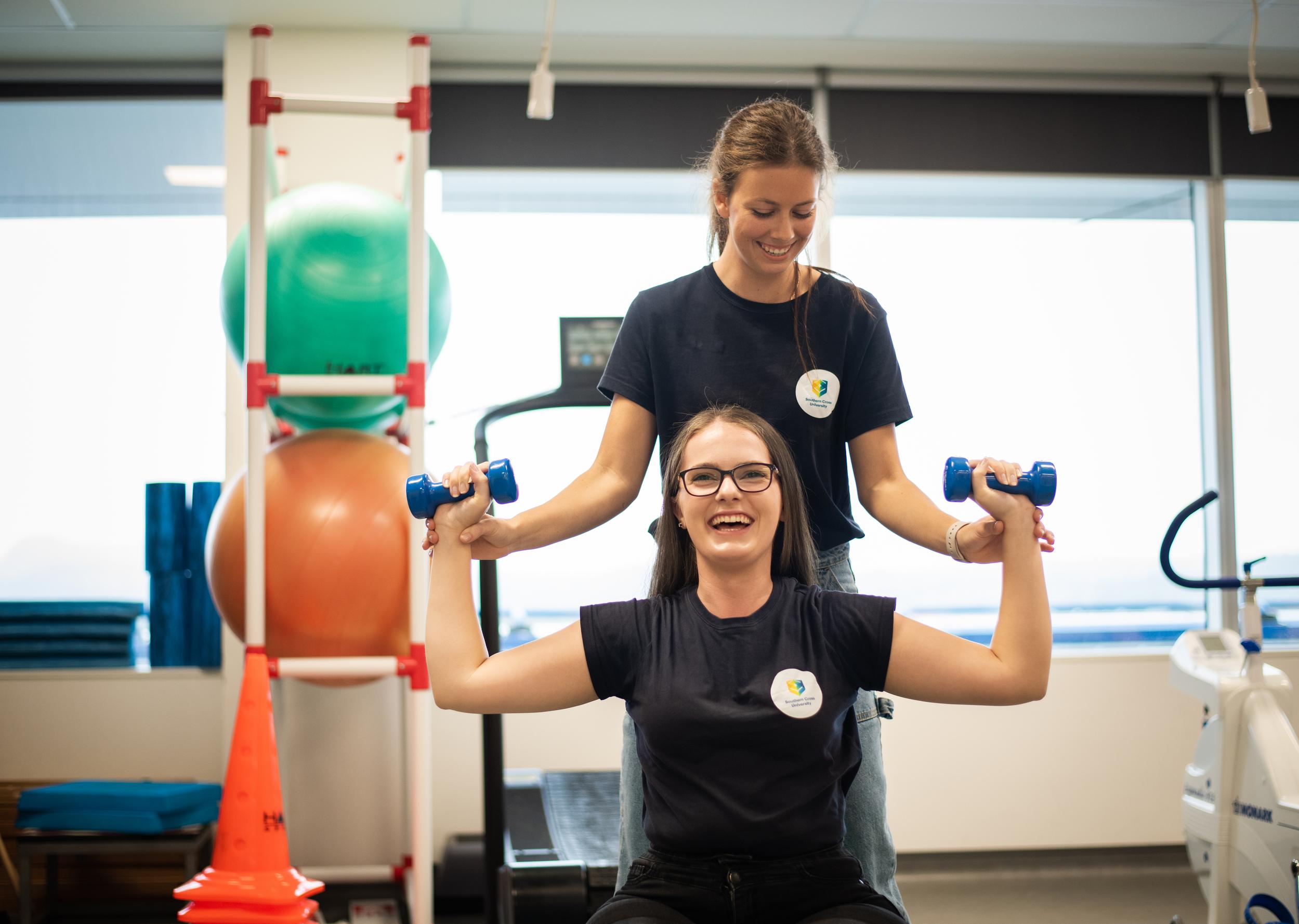 Two women using weights