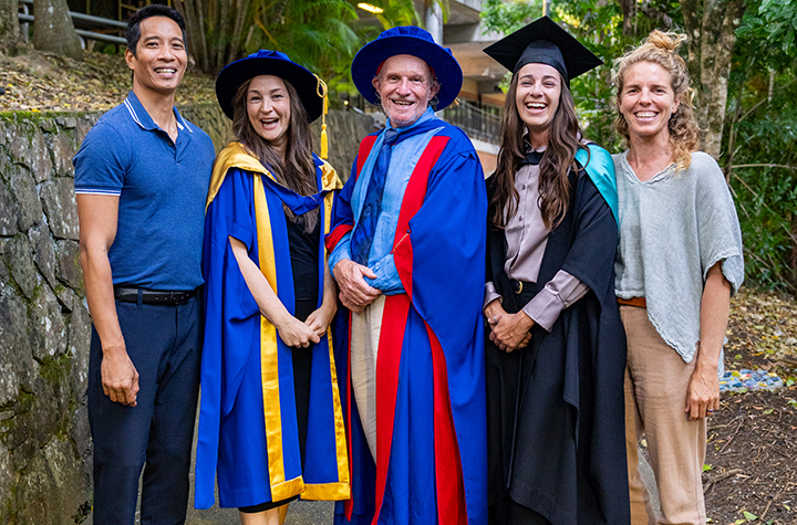 Academics in gowns with supporters at a graduation event