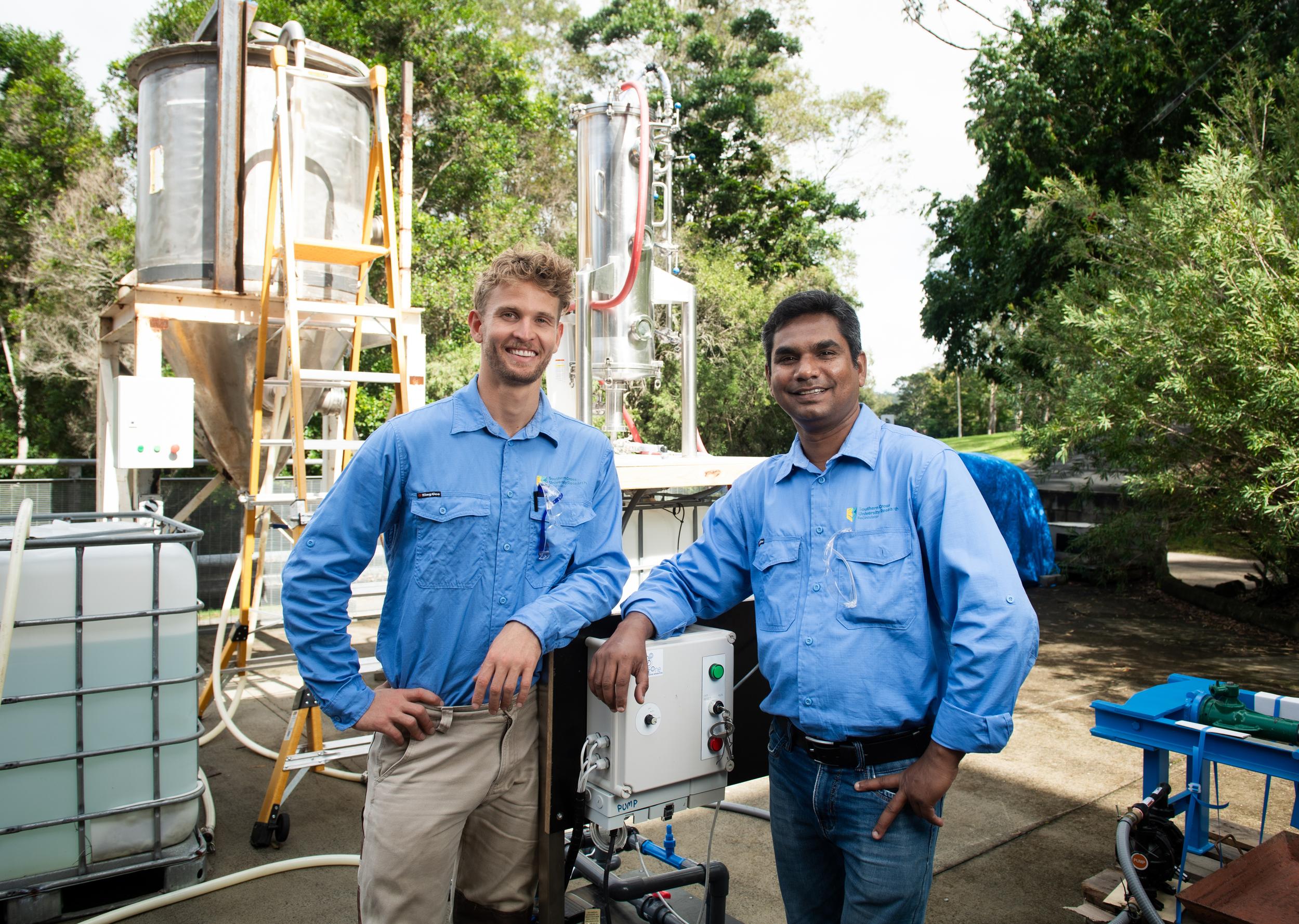 Two people in blue work shirts at work site