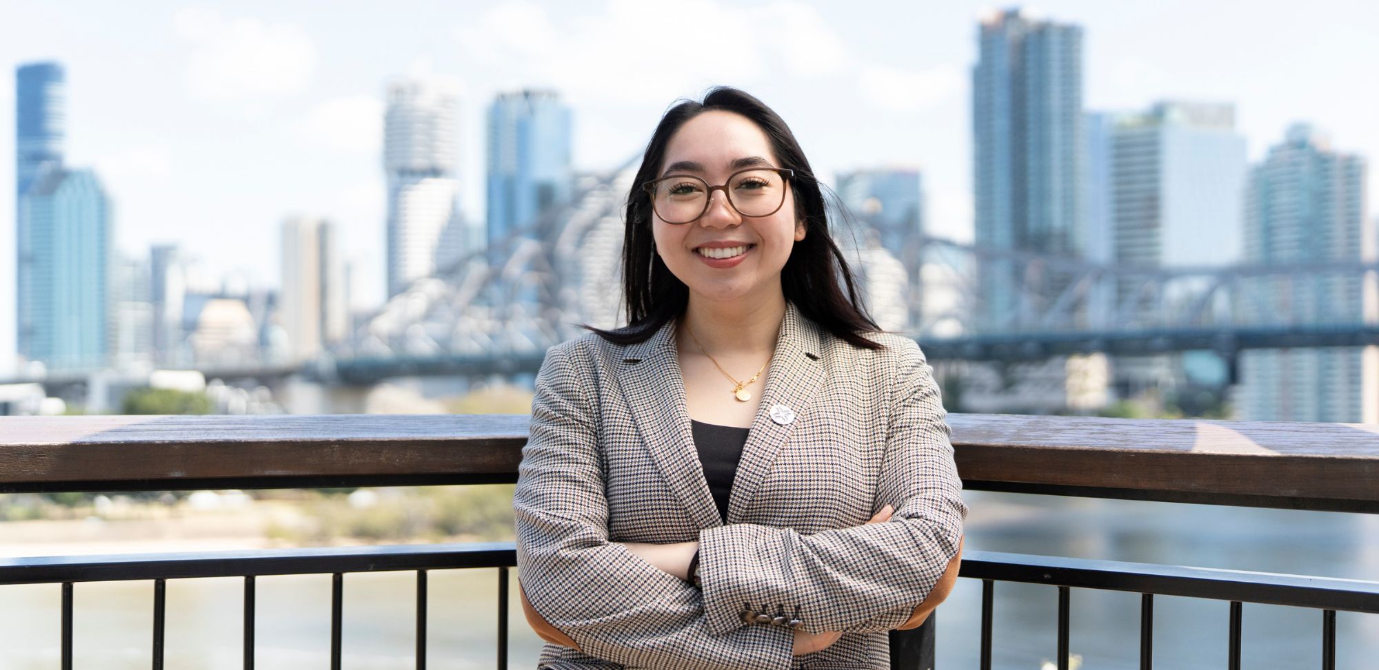 Women smiling with city in the background