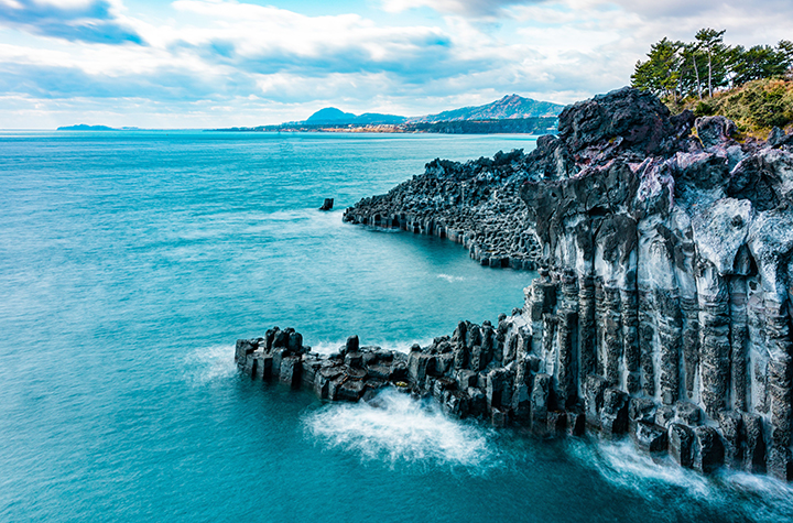 Jeju Island South Korea credit Ethan Brooke on pexels 2000x973.jpg Dramatic cliffs and vibrant ocean off an island