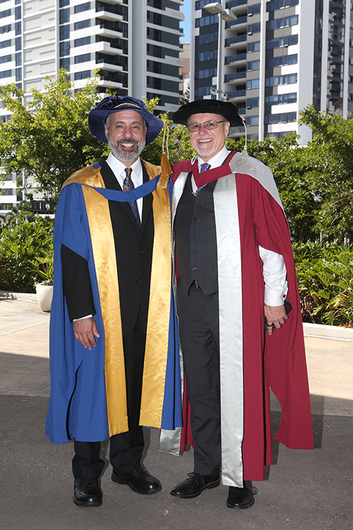 Two men in graduation gowns