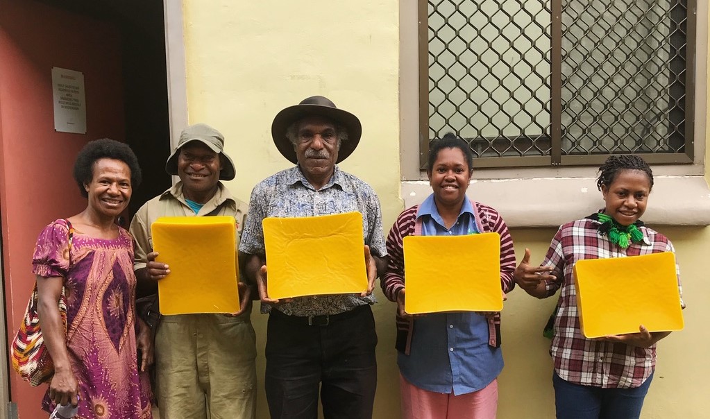 Group holding beeswax