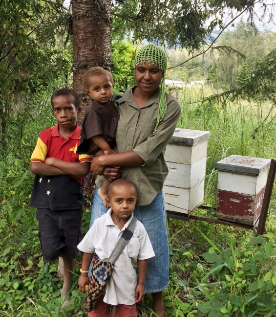 Women and children with bee hives