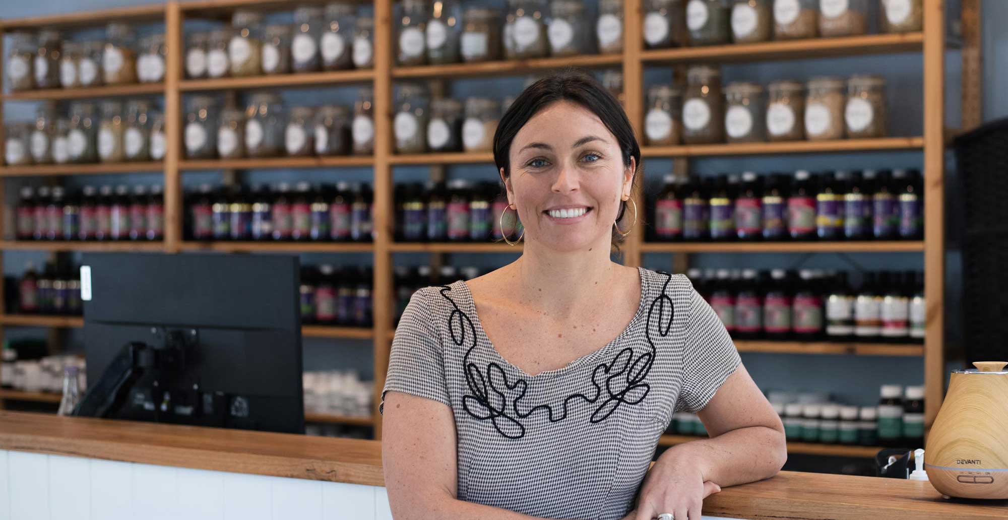 Naturopathic medicine student standing in front of shelf of jars