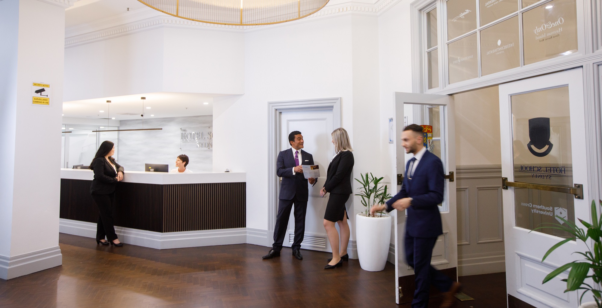 A group of people in a foyer and reception area