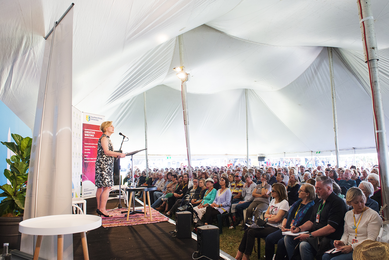 A women presenting to a large crowd at Byron Writers Festival