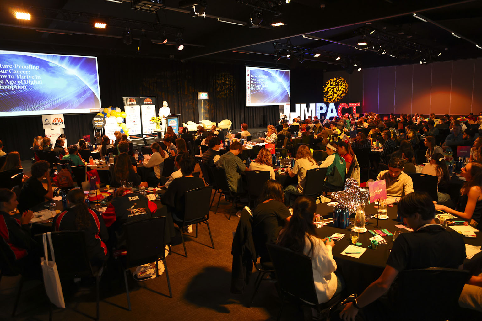 Conference room filled with students at the IMPACT Youth Summit
